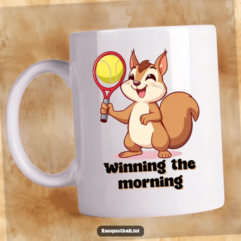 Funny mug showcasing a delighted squirrel striking a victory pose after catching a racquetball, radiating pure, humorous triumph.
