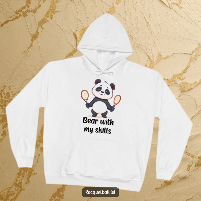 Funny hoodie with a curious panda comically juggling two tennis racquets, offering warmth and a dose of athletic humor.