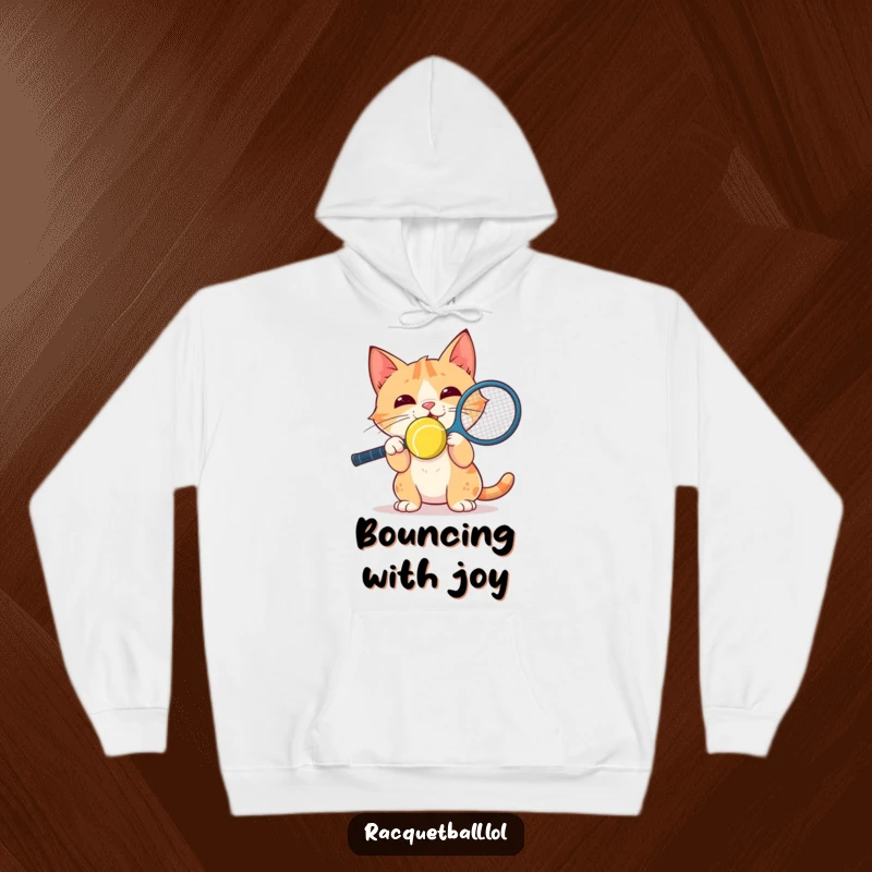 Funny Hoodie: A delighted cat balances a racquetball on its nose with intense focus, perfect for cozying up with a smile.