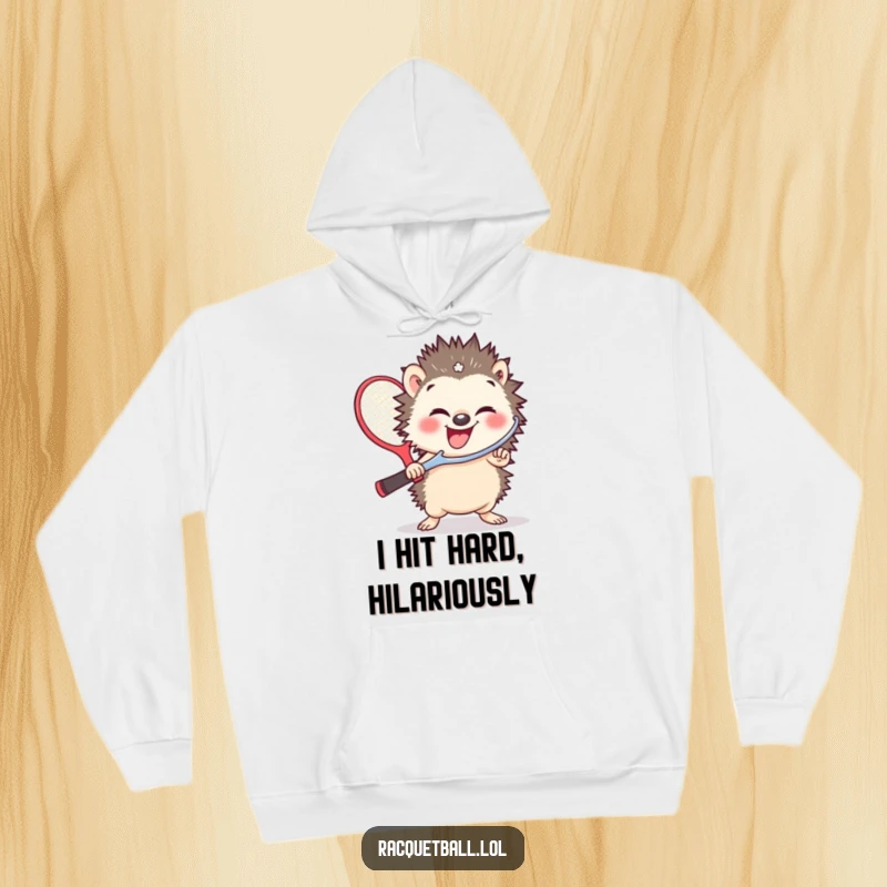 Funny hoodie featuring a small hedgehog in a fit of giggles, gripping an absurdly large racquetball paddle, radiating pure joy.