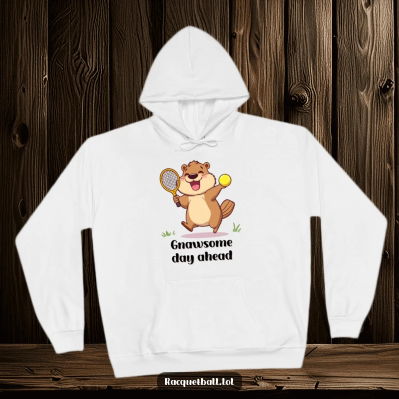 Funny hoodie showcasing an overjoyed beaver leaping with a racquetball paddle, ready to strike a speeding ball with excitement.