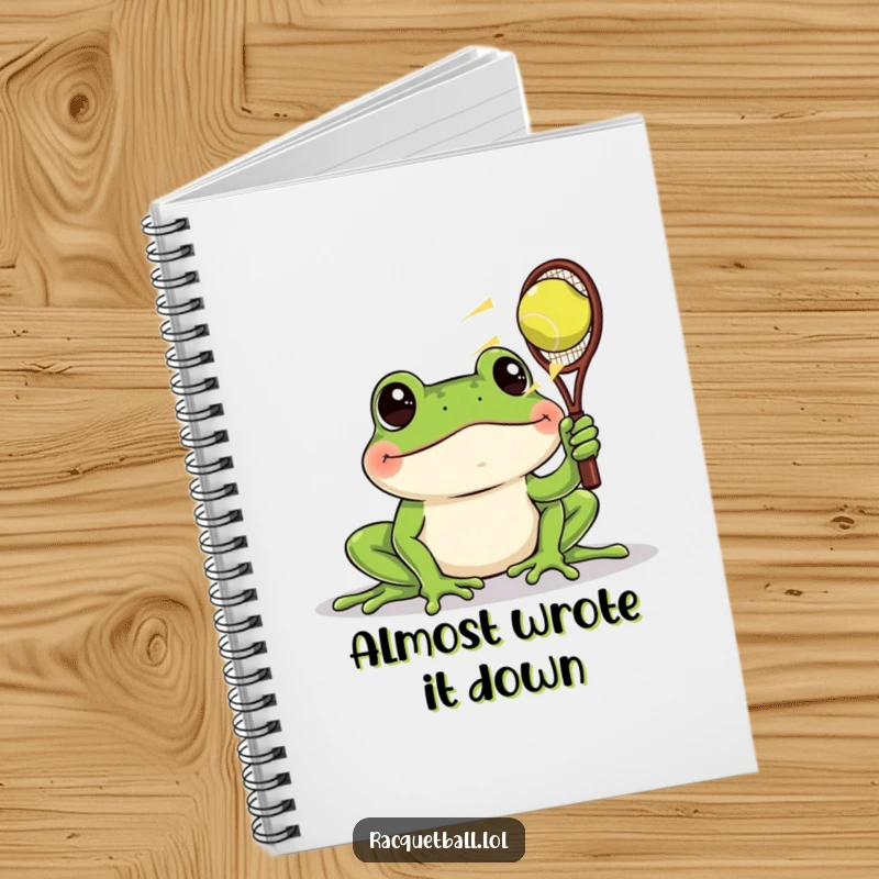 Funny notebook cover featuring a frog with wide eyes watching a racquetball zoom past, perfect for noting funny observations.