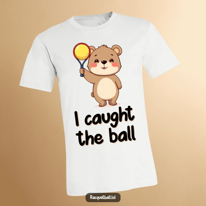 Funny T-Shirt: Curious bear triumphantly holds a tiny racquetball, symbolizing a humorous sports victory.