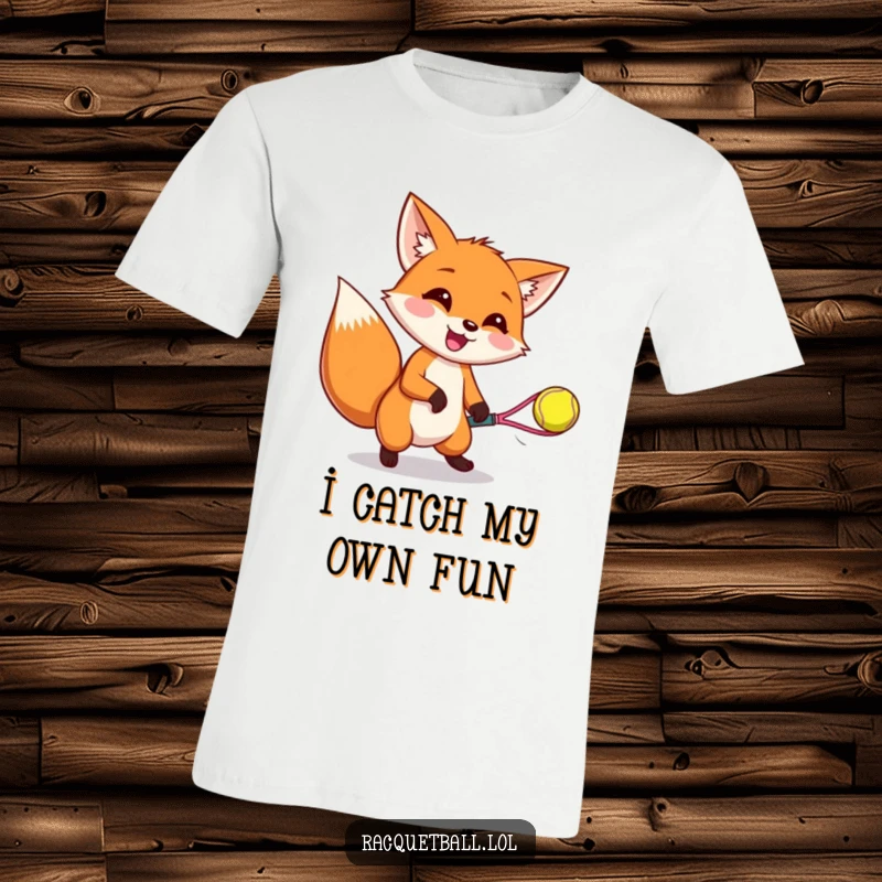 Funny t-shirt displaying a gleeful fox with ears perked, catching a bouncing racquetball, highlighting playful determination and athletic fun.