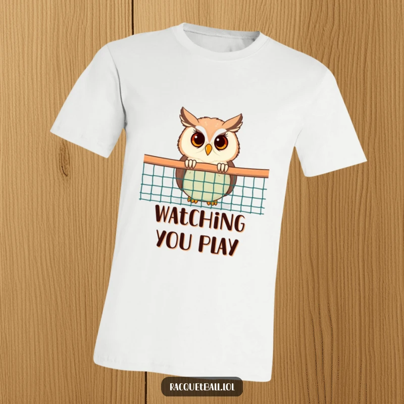 Funny Owl T-Shirt: A curious cartoon owl peeking from behind a racquetball net, printed on a tee for the observant fan.