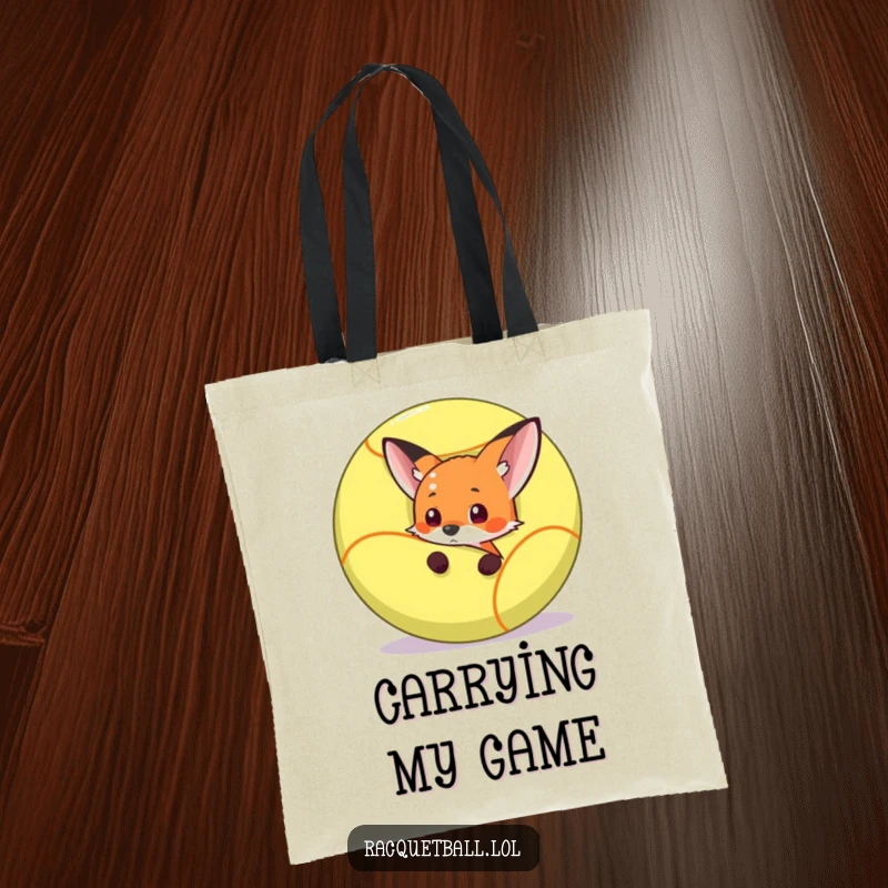 Funny fox peeking out from behind a giant racquetball, ready to pounce, on a durable and funny tote bag.